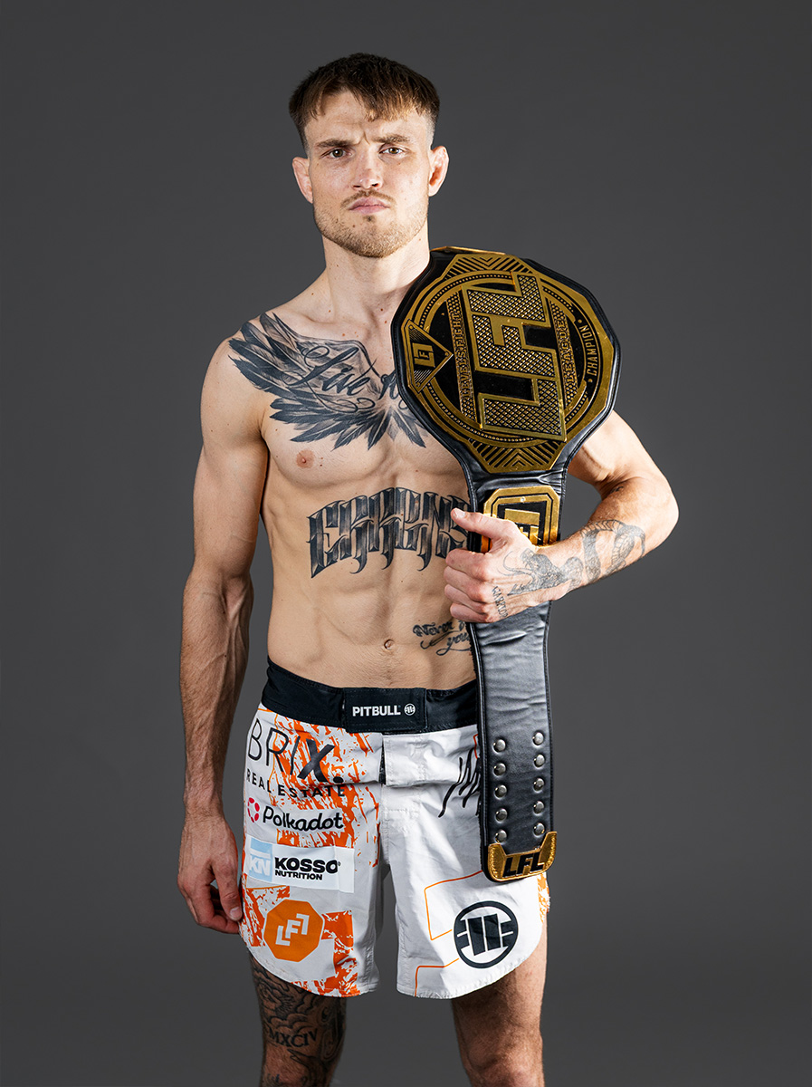 Coach posing with his prize belt